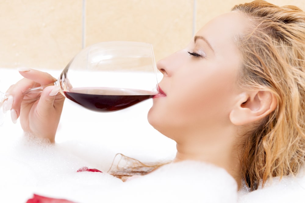 woman in bath with wine