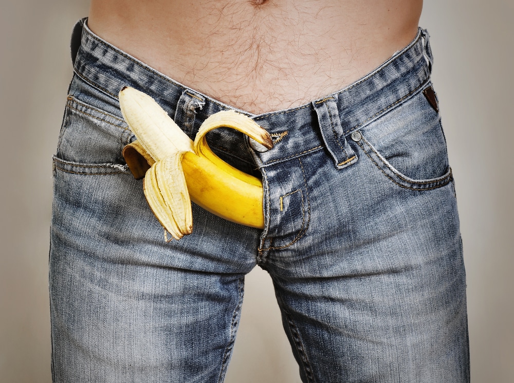man with jeans and banana