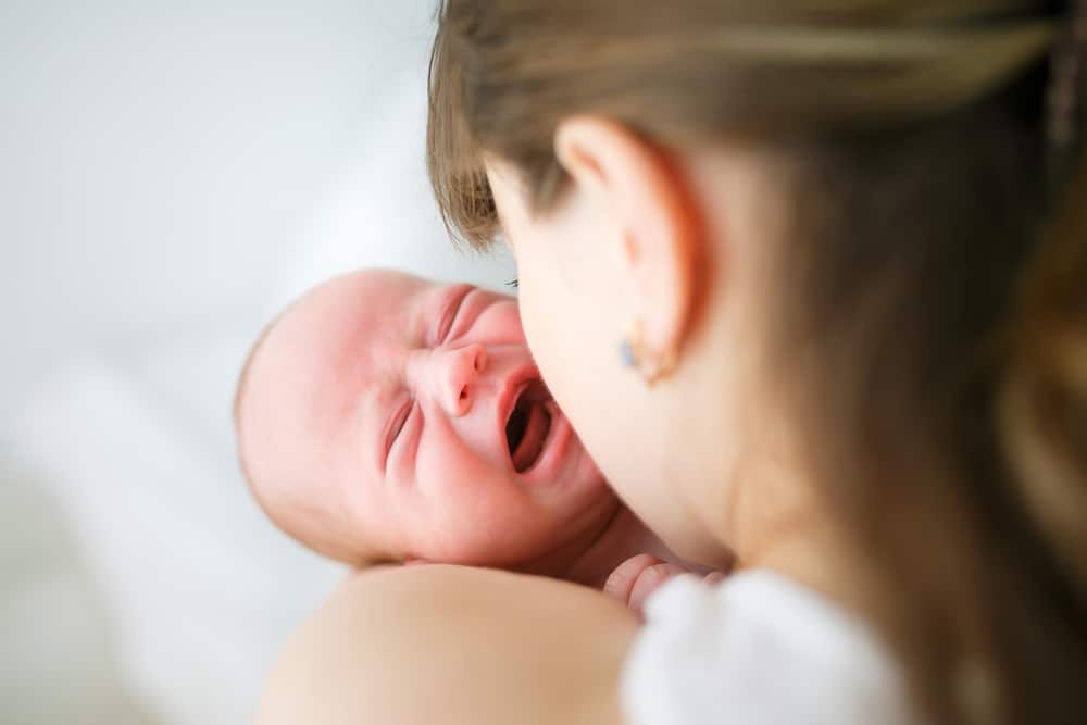 woman with newborn crying