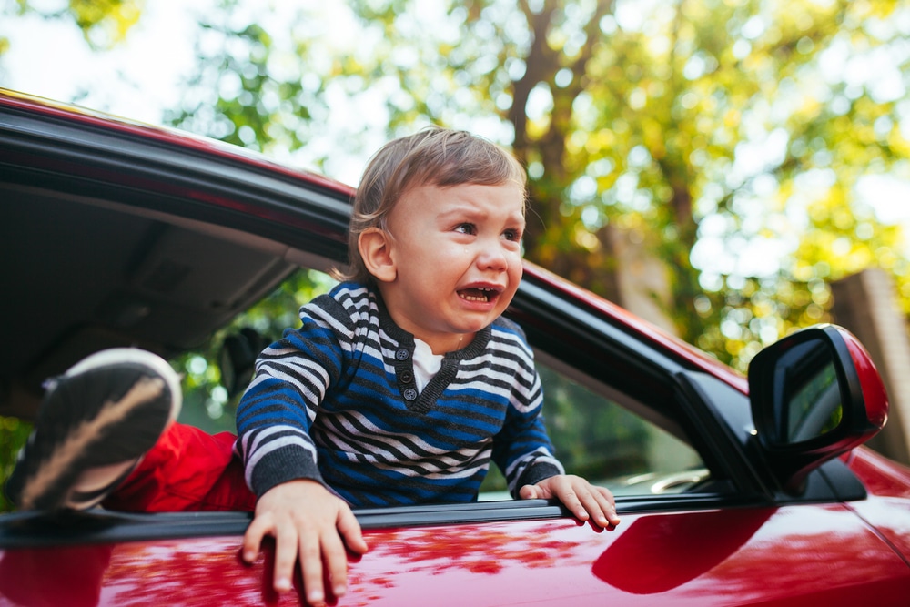 crying baby boy in a car
