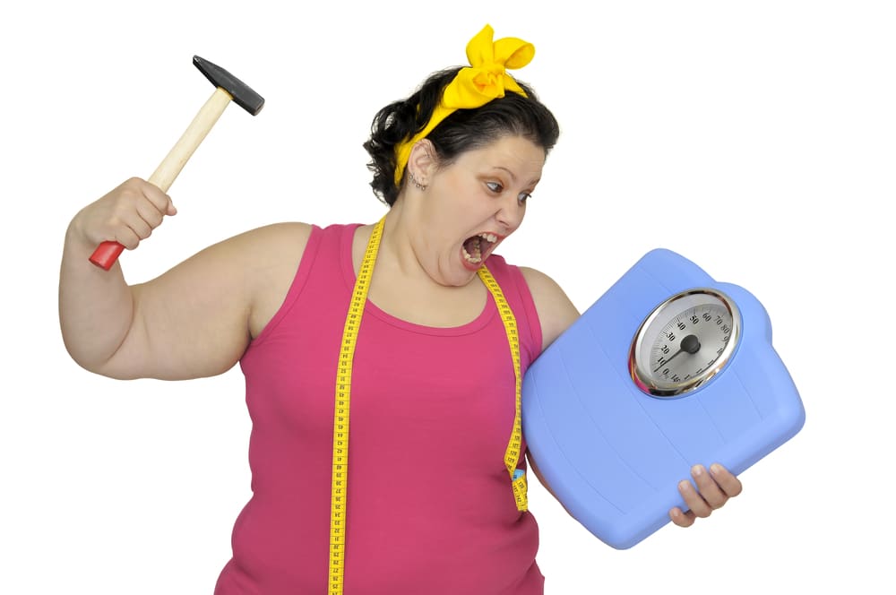 angry woman breaking scale