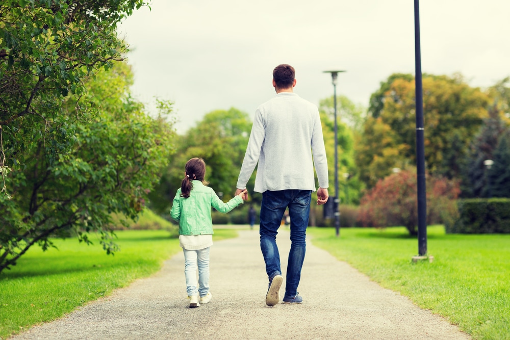 little girl walk away with father