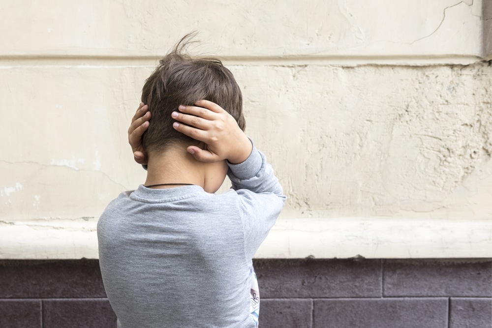 boy with hands on ears