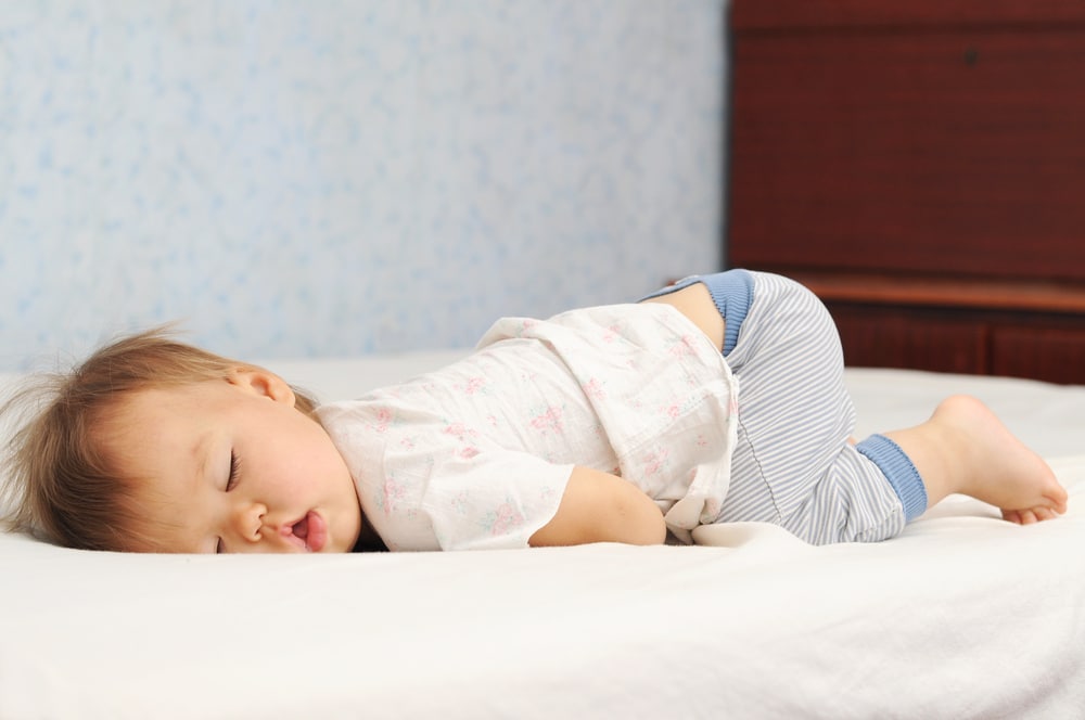 kid sleeping in a funny position