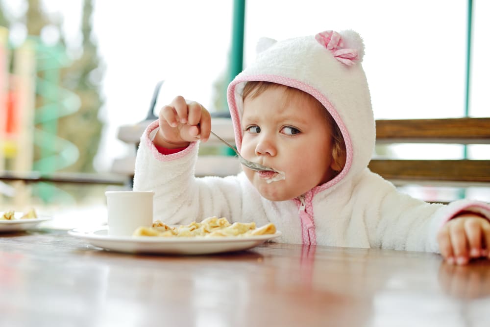 little girl eating restaurant