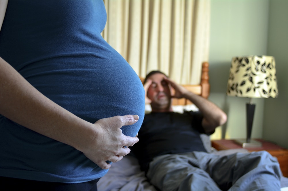 pregnant woman with unhappy man
