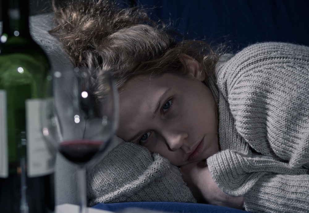 sad woman drinking wine