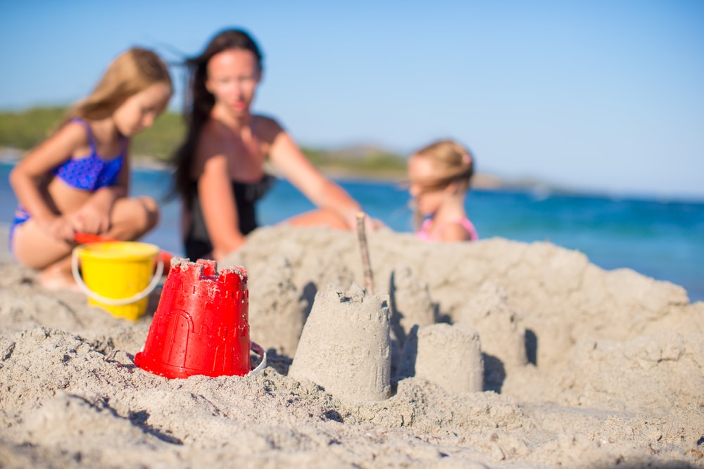 mother play with kids in the sand