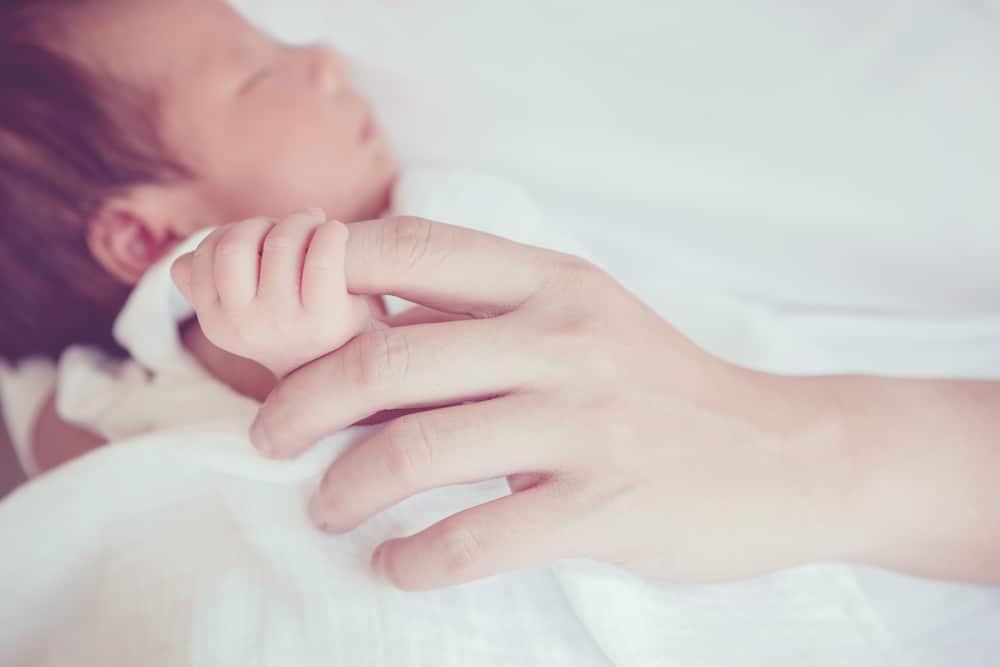 newborn with mother's finger