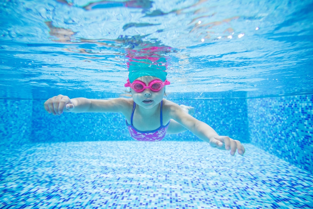 Little,Girl,Diving,In,Swimming,Pool
